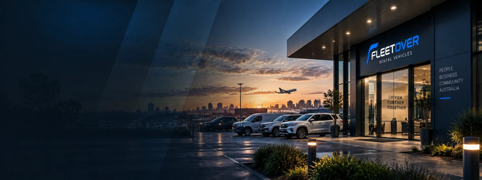 Fleetover rental branch at dusk with SUVs and vans parked outside and a city skyline behind